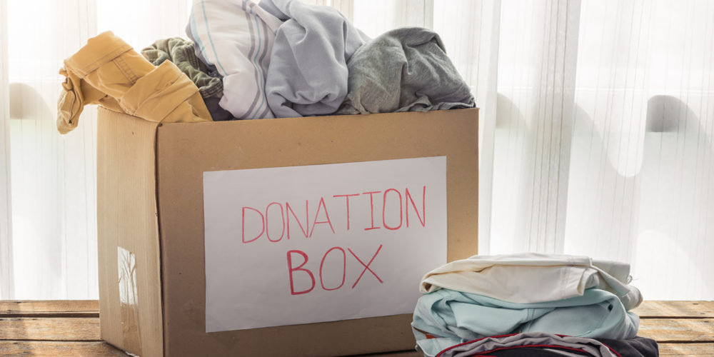 Clothing donation box on wooden background